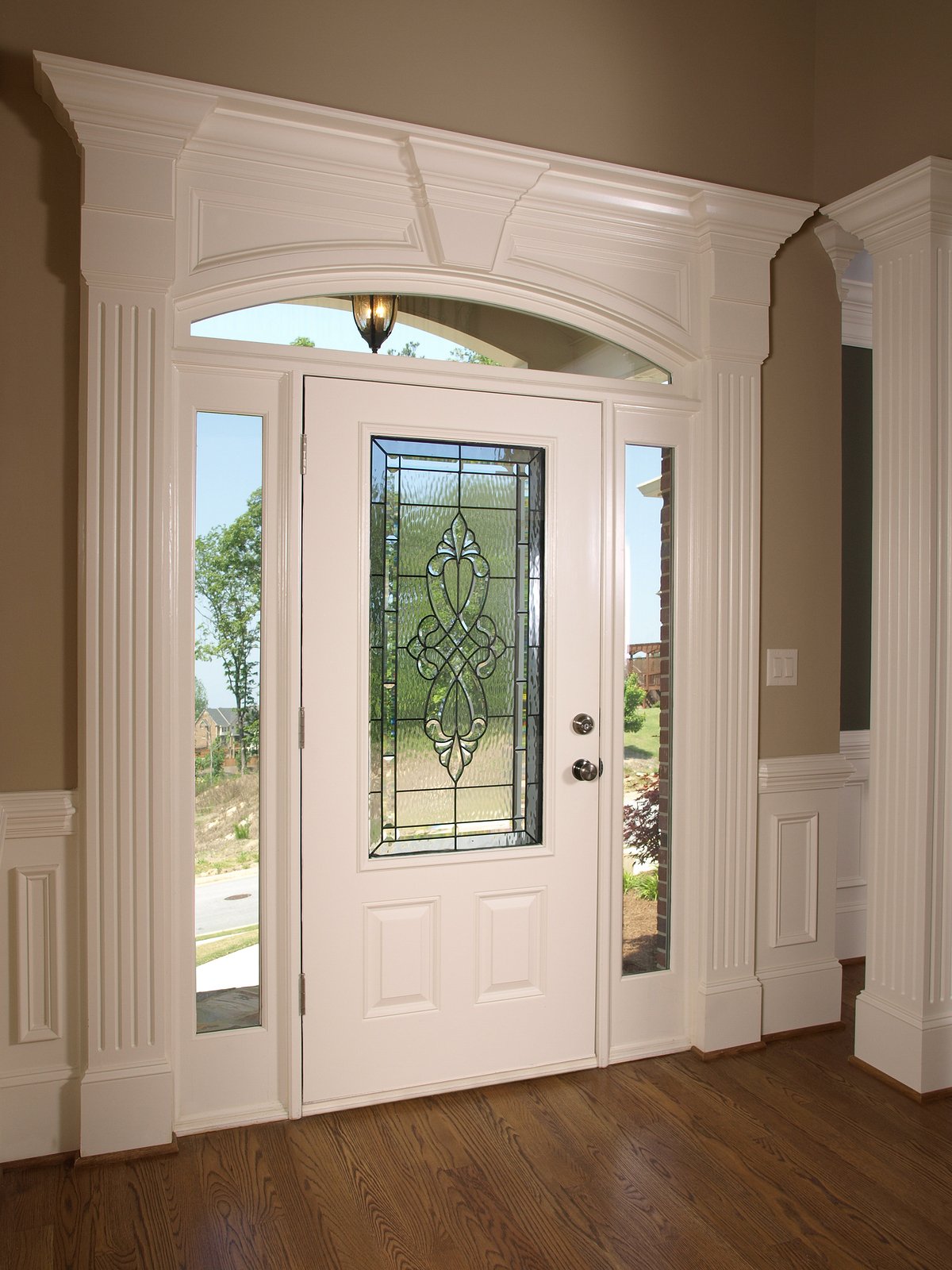 White front door with decorative glass center 
